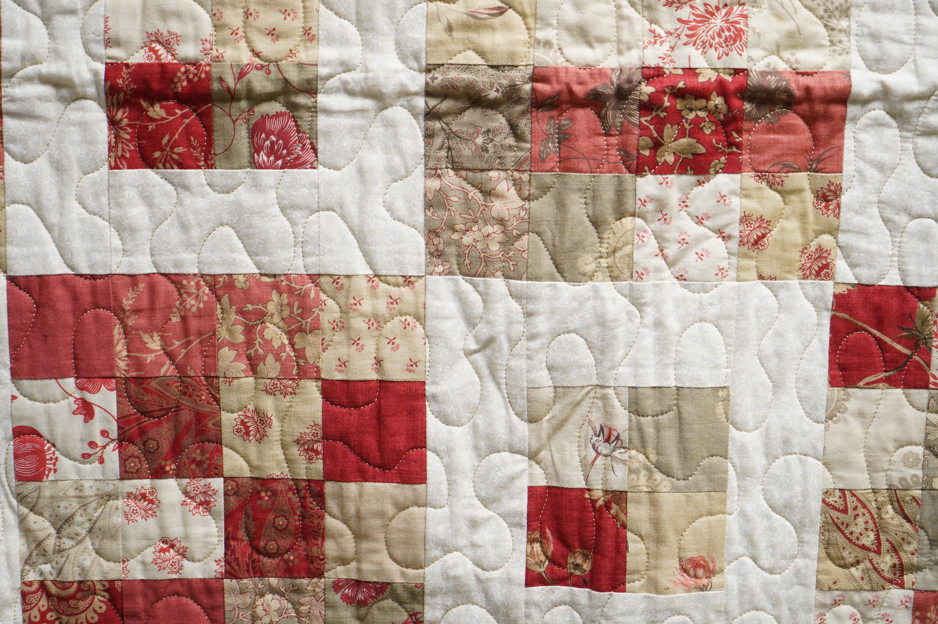 A contemporary patchwork quilt, with label: Quilts from the shed, handmade with love by Suzanne. 138cm x 136cm